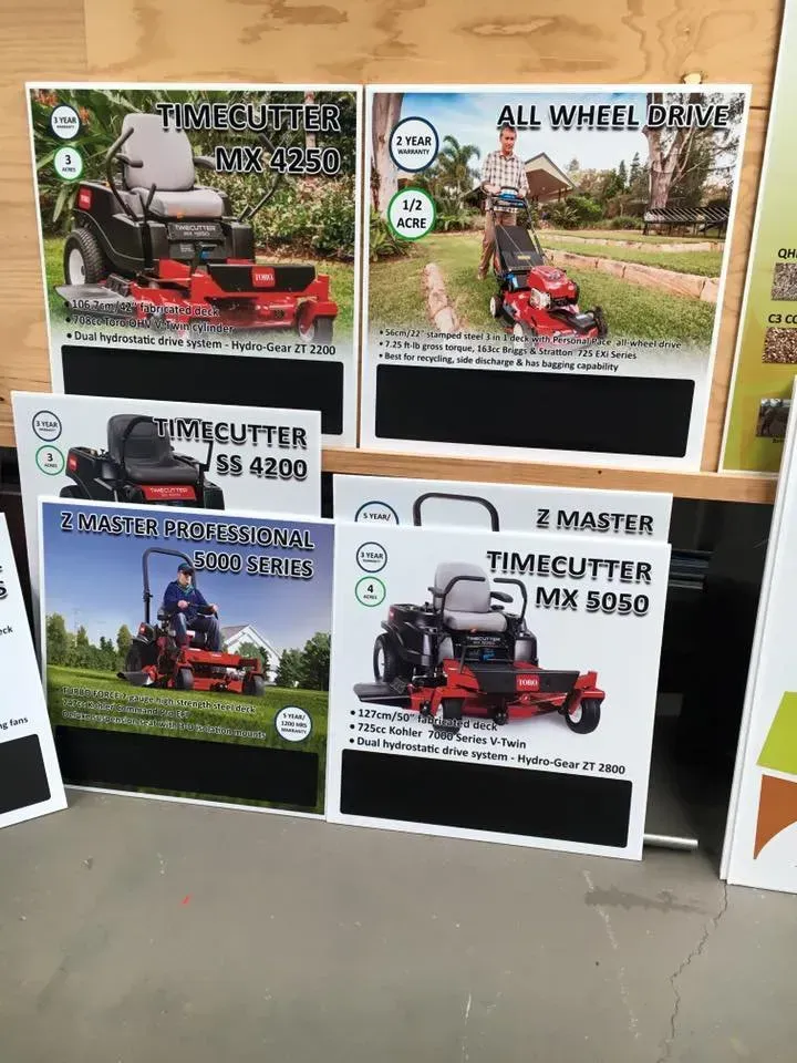 A man is riding a lawn mower on a wooden table.
