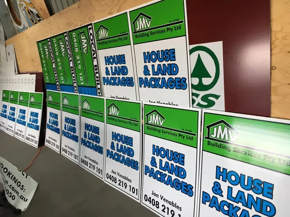 A row of signs that say house and land packages