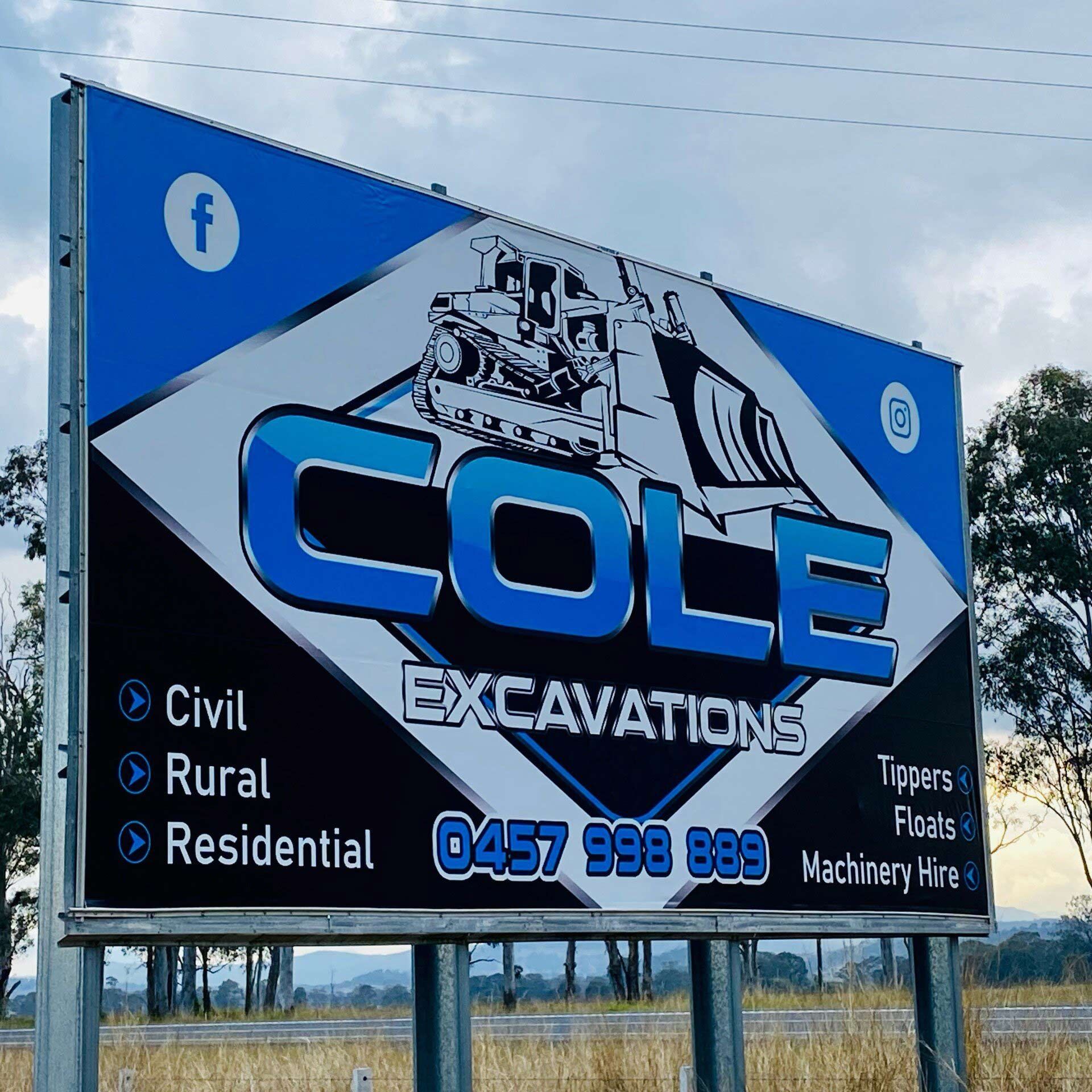 A large blue and black billboard for cole excavations