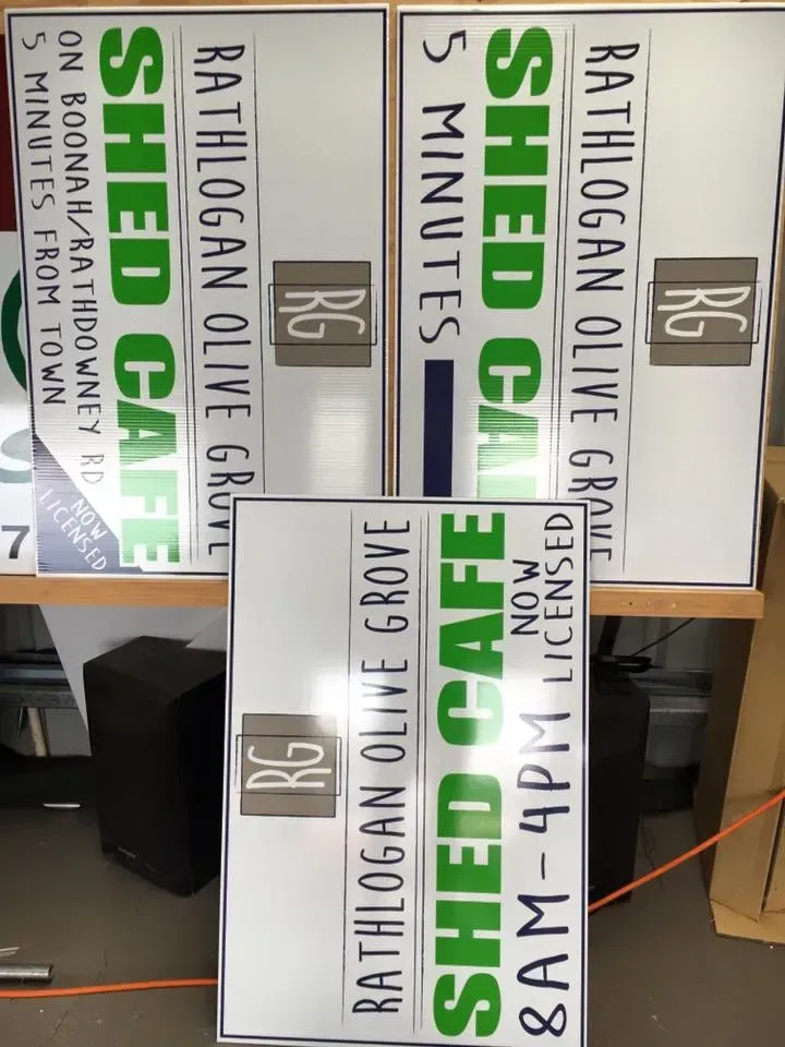 Several signs for the rathlogan olive grove shed cafe