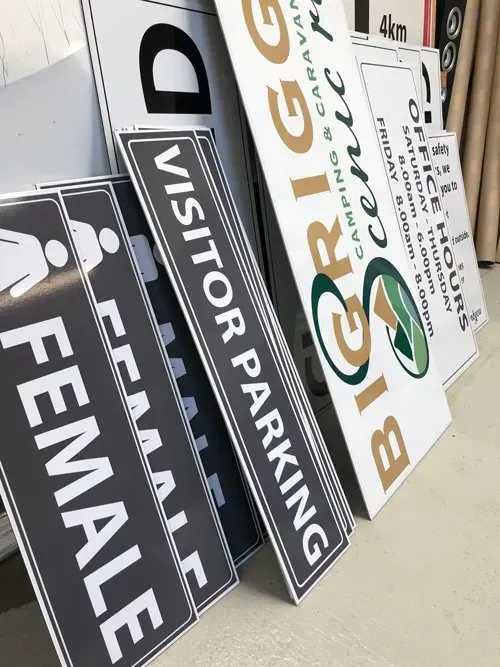 A row of signs including one that says female
