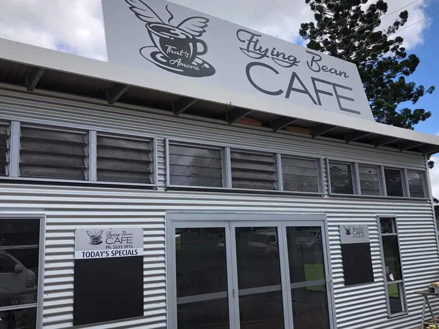 A building with a sign that says flying bean cafe on it.