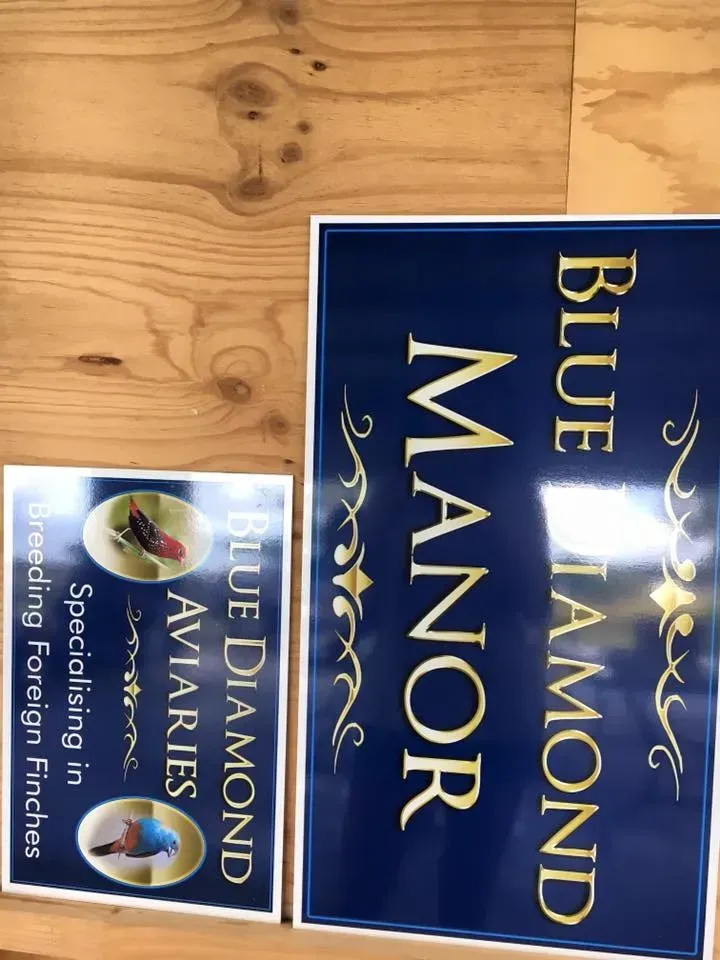 A blue and gold sign for blue diamond aviaries