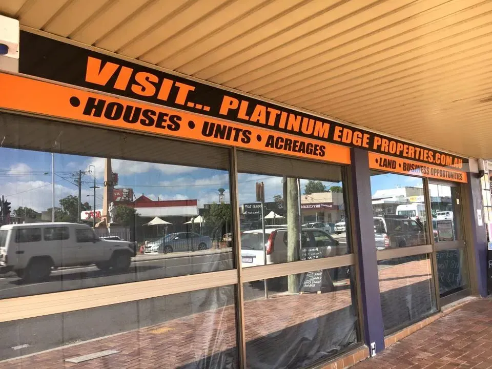 A building with a sign that says visit platinum edge properties