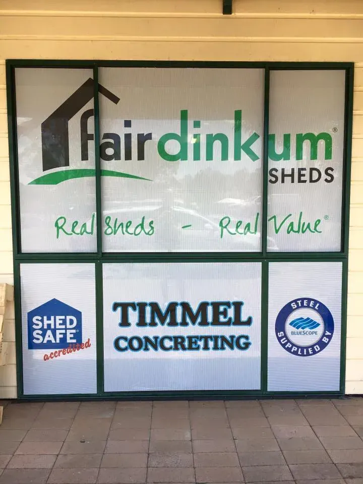 A window with a sign on it that says fairdinkum sheds