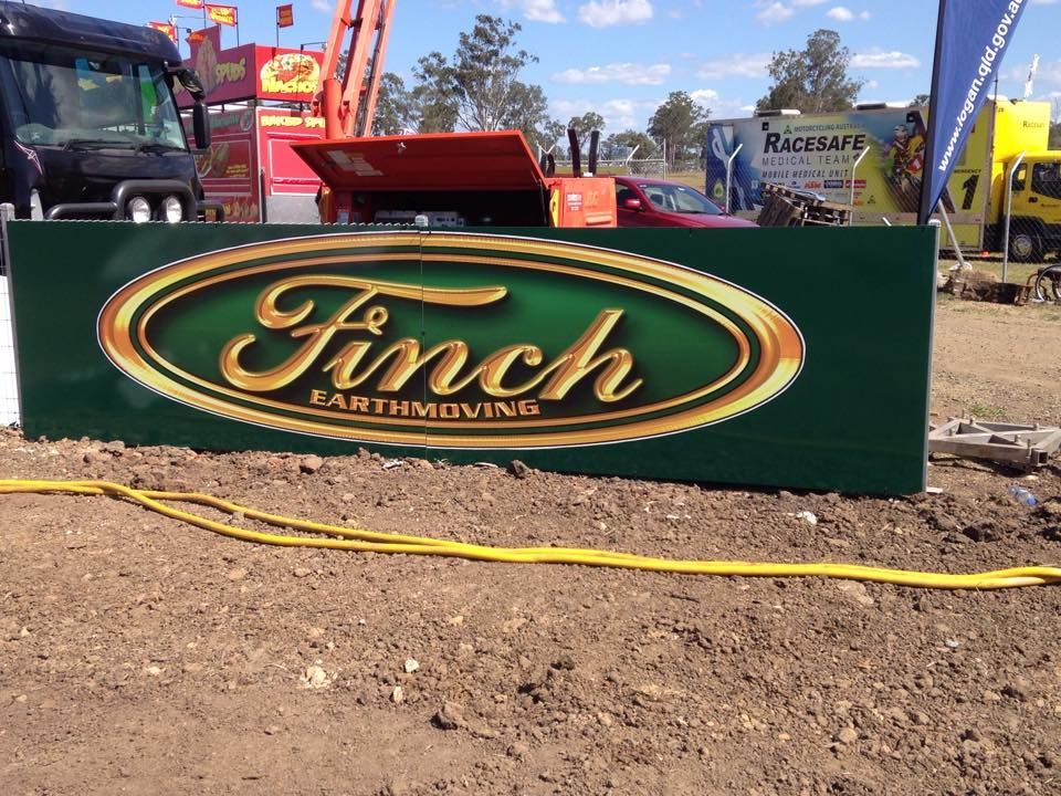A green sign that says finch earthmoving on it