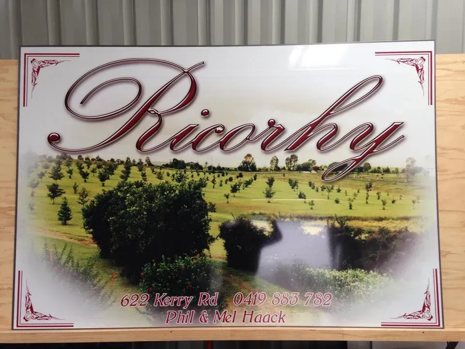 A sign that says riverby is on a wooden table