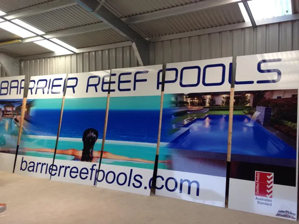 A sign for barrier reef pools hangs in a building