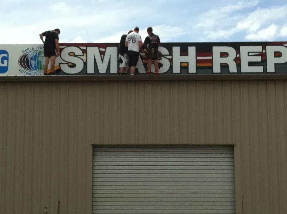 A group of people standing on top of a smash rep sign