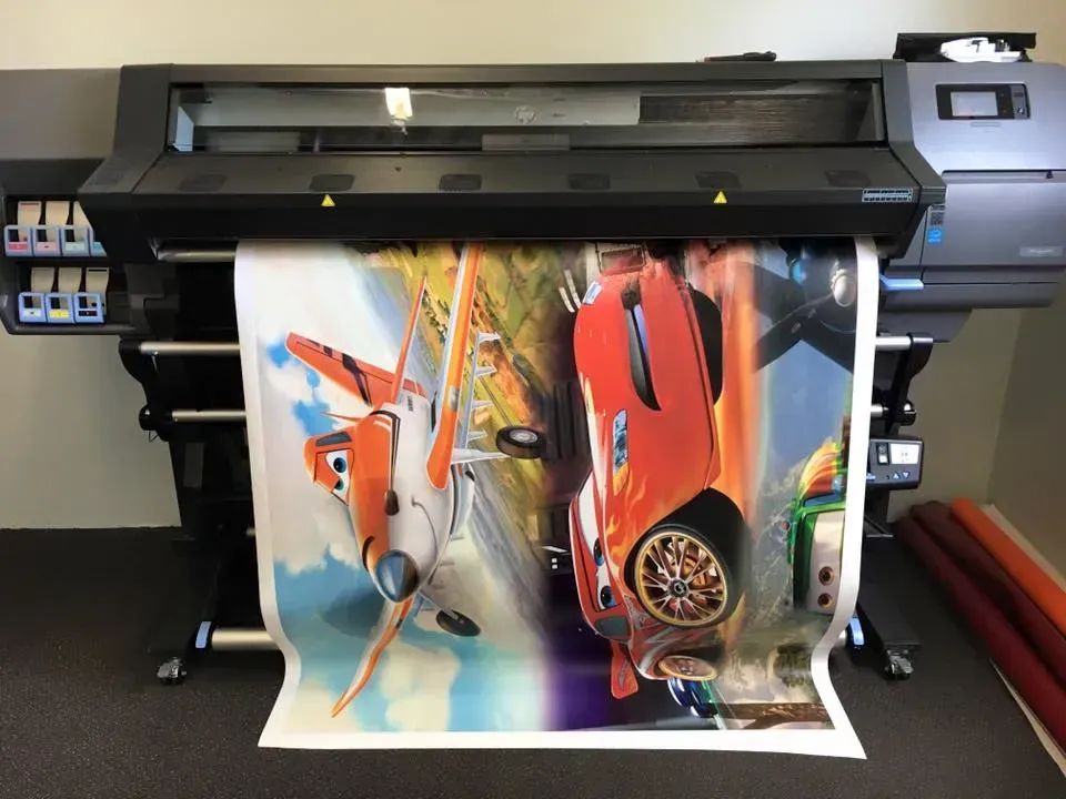 A large poster is being printed on a large printer