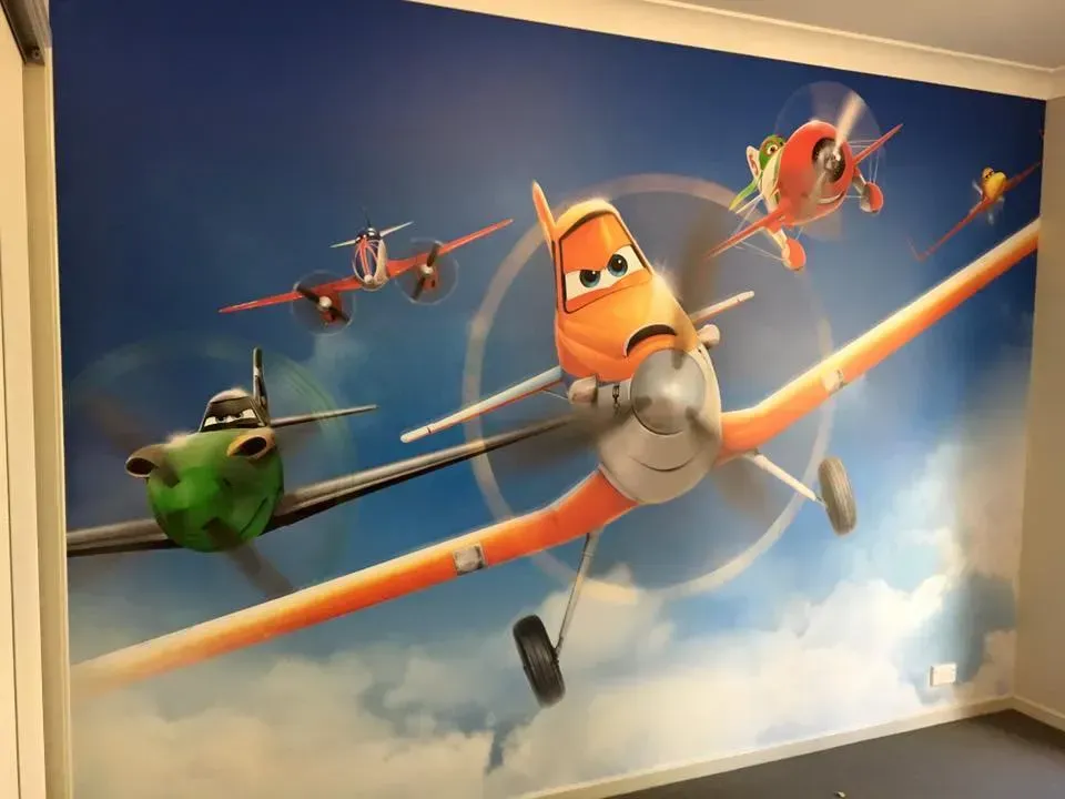 A wall with a picture of planes on it