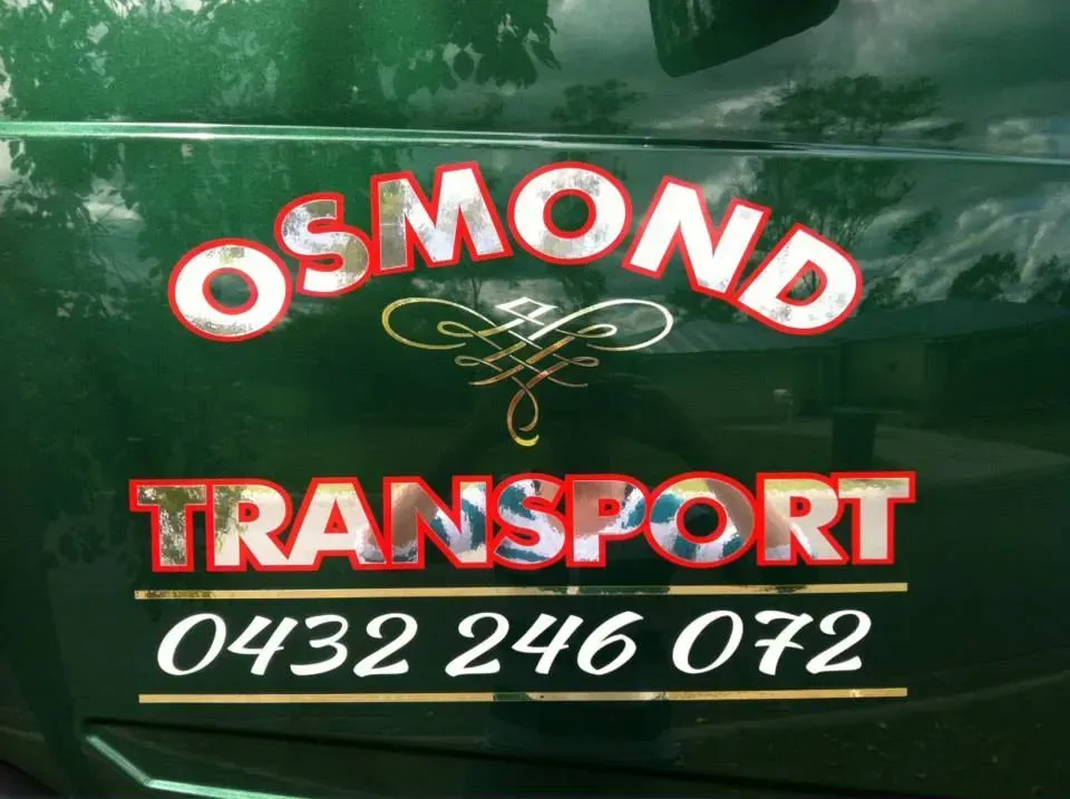 A green van with osmond transport written on it