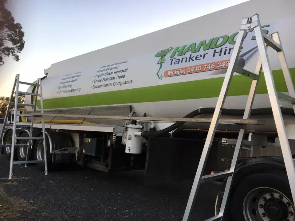 A ladder is attached to the side of a tanker truck