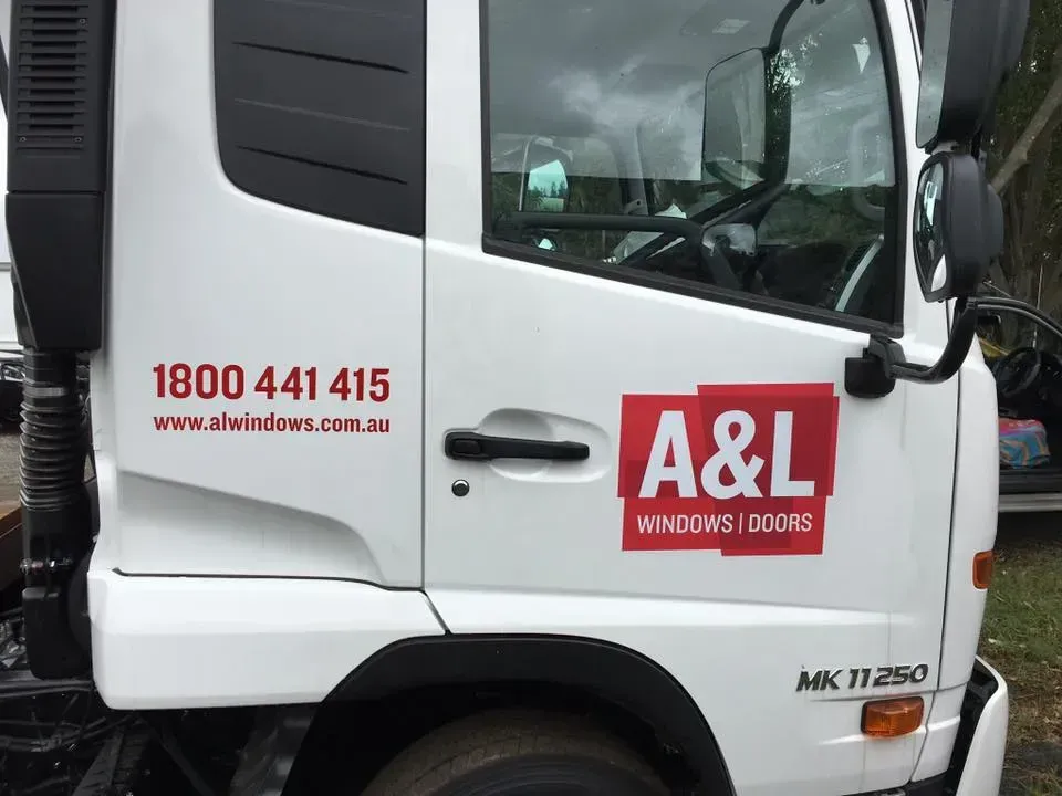 A white truck with the word a & l on the side of it