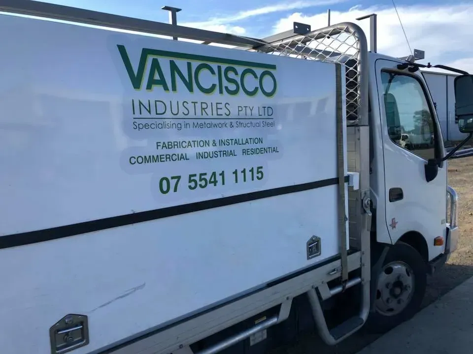 A vancisco industries truck is parked on the side of the road.