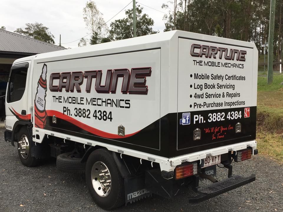 A car tune truck is parked in front of a house