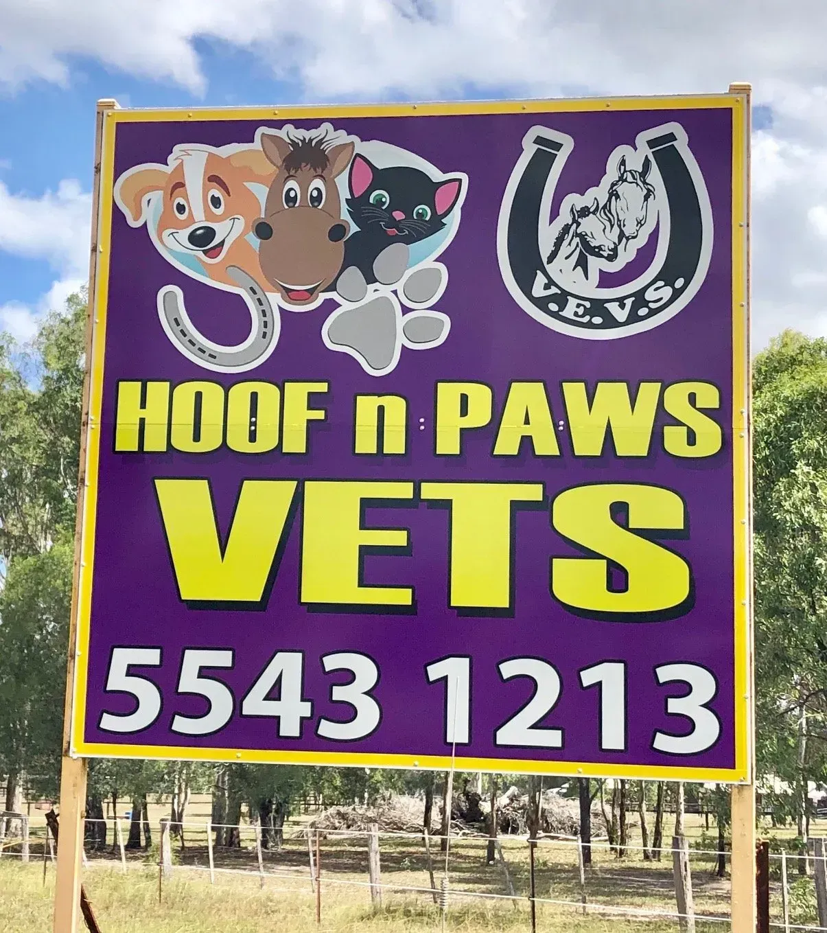 A purple sign that says hoof n paws vets on it