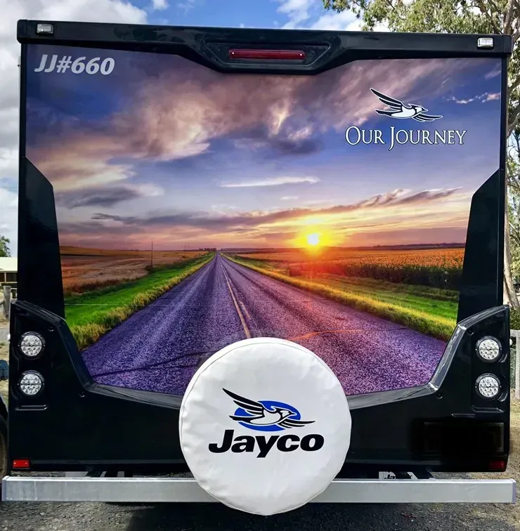 The back of a jayco rv with a tire cover on it.