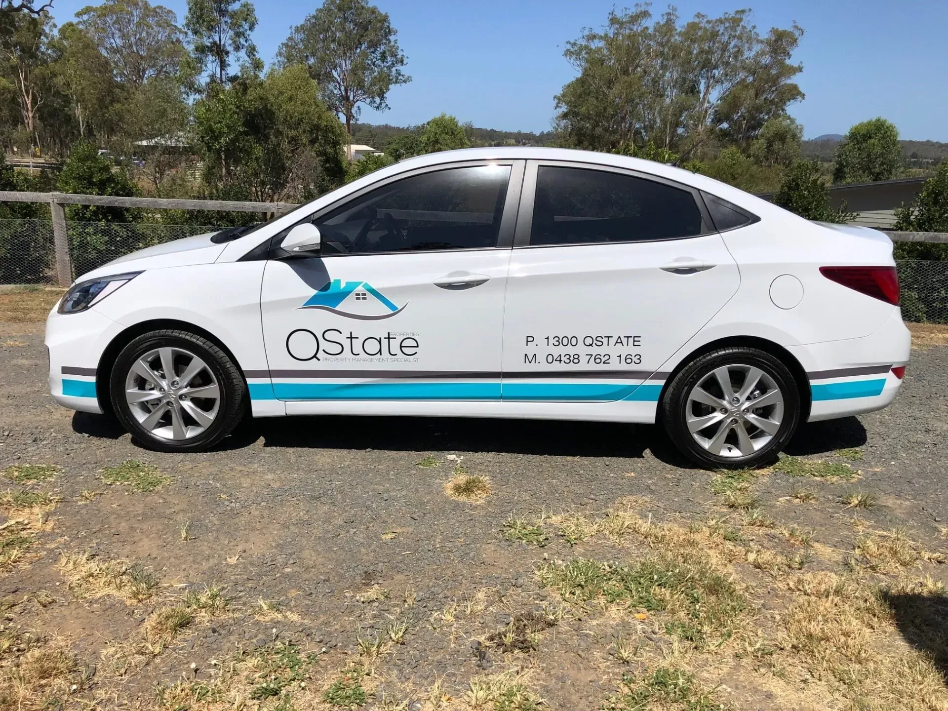 A white car is parked on the side of the road.