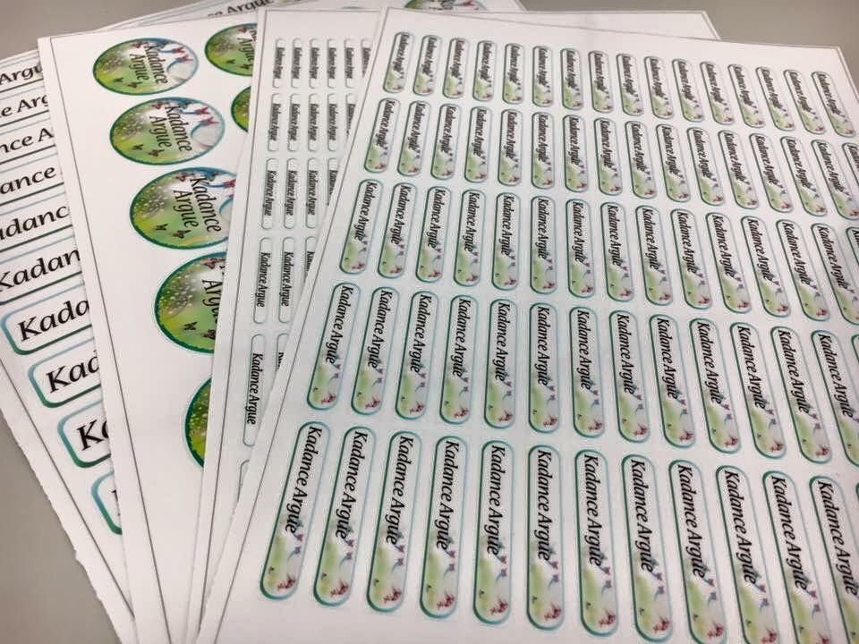 A bunch of stickers are sitting on top of each other on a table.