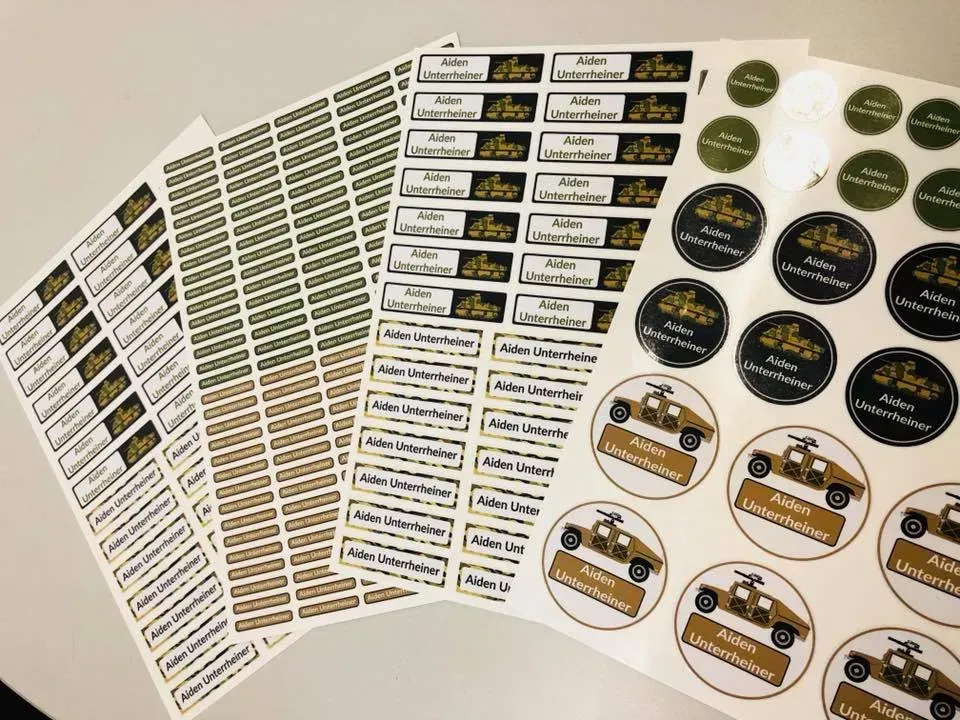 A bunch of stickers are stacked on top of each other on a table.