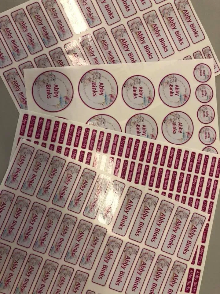 A bunch of name labels are sitting on top of each other on a table.