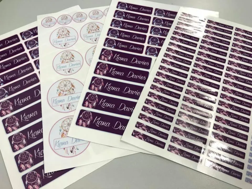 A bunch of stickers are sitting on top of each other on a table.