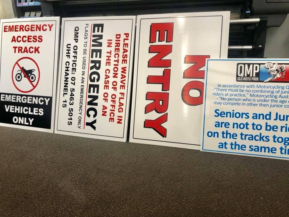 Several signs including one that says emergency access track