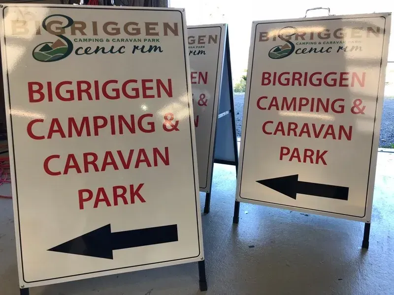 Three signs pointing to bigriggen camping and caravan park