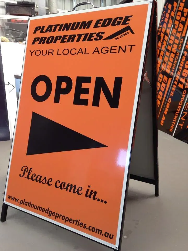 A sign that says platinum edge properties your local agent open