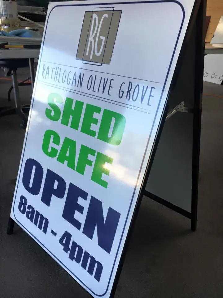 A sign that says shed cafe open 8 am-4pm