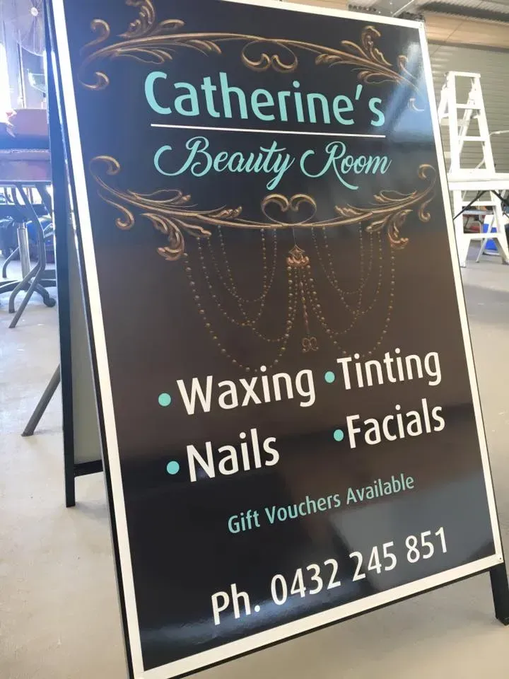 A sign for catherine 's beauty room advertising waxing tinting nails and facials