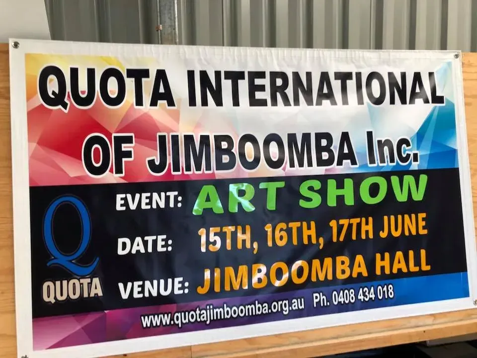 A sign that says ' quota international of jimboomba inc ' on it