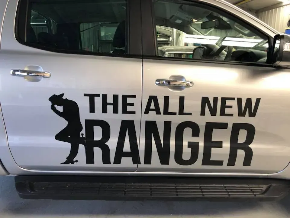 A silver truck with the words the all new ranger on the side