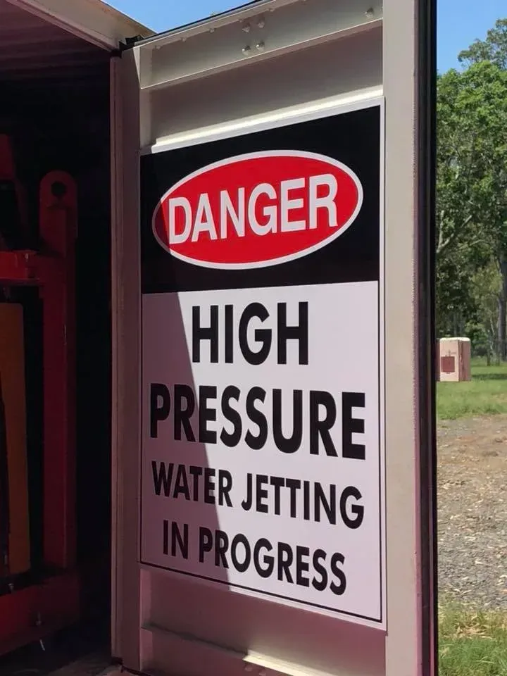 A sign that says danger high pressure water jetting in progress