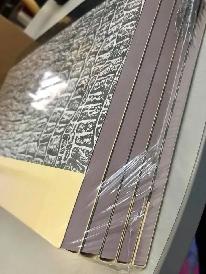 A stack of cardboard boxes wrapped in plastic on a table