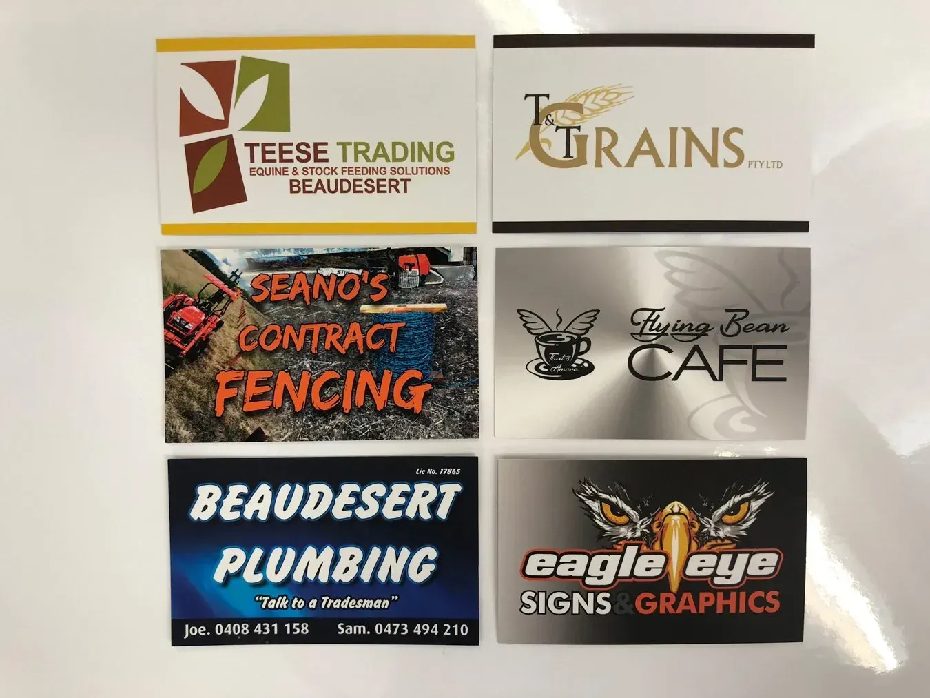 A collection of business cards including one for beaudesert plumbing