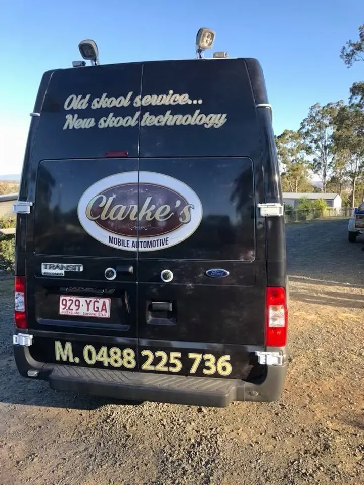 The back of a black van that says clarke 's on it