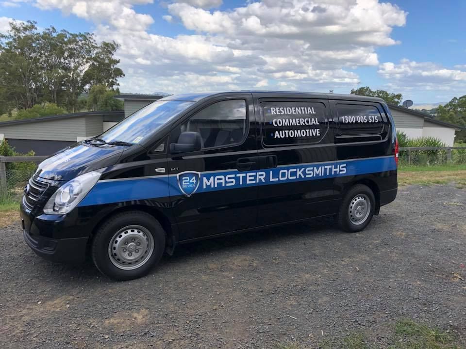 A black van is parked on the side of the road.
