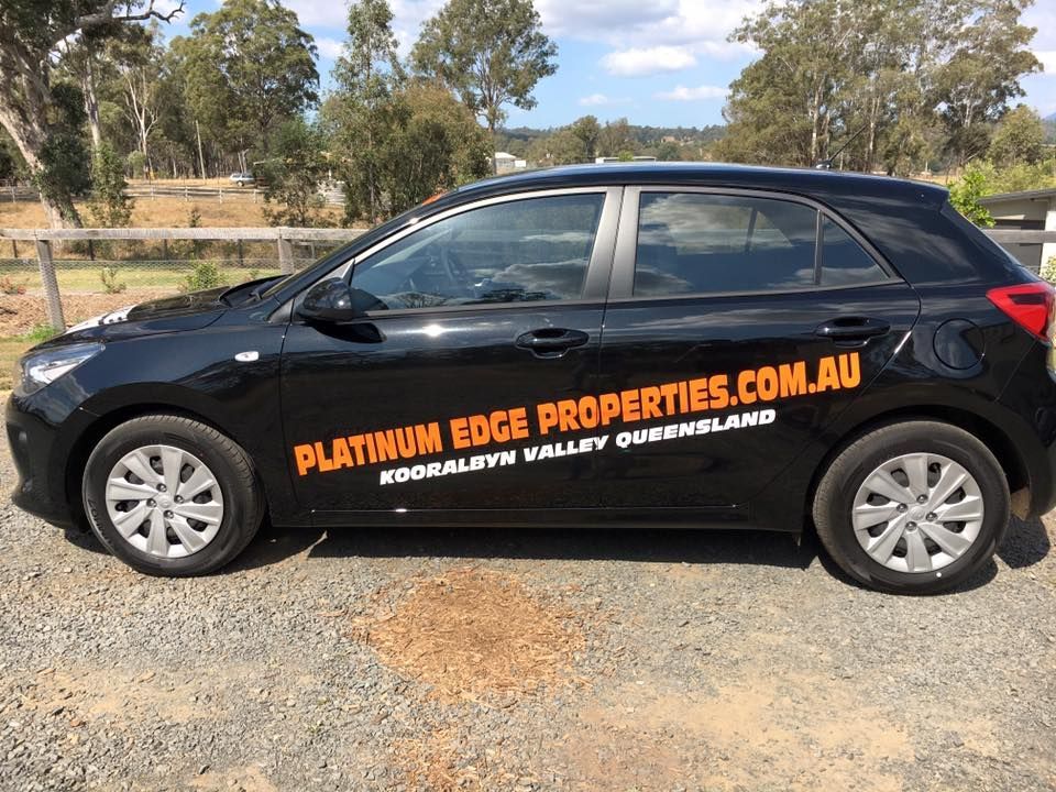 A black car with platinum edge properties.com.au written on it