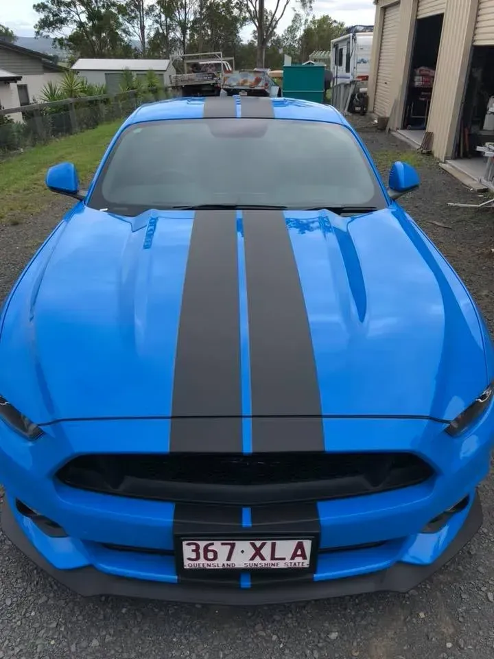 A blue car with a license plate that says 367 xl a