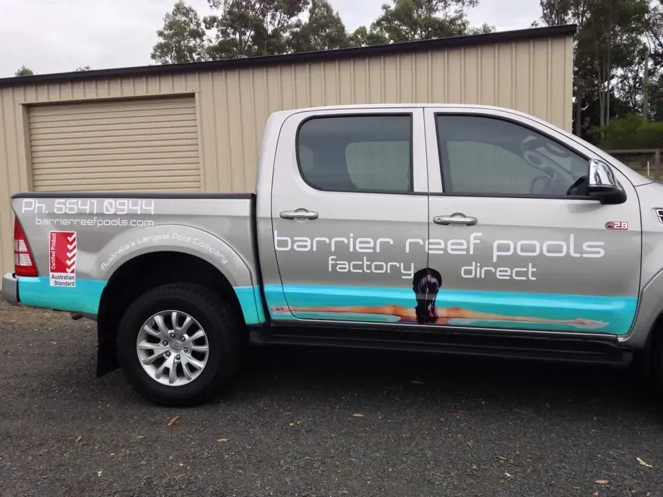 A truck with barrier reef pools factory direct written on the side