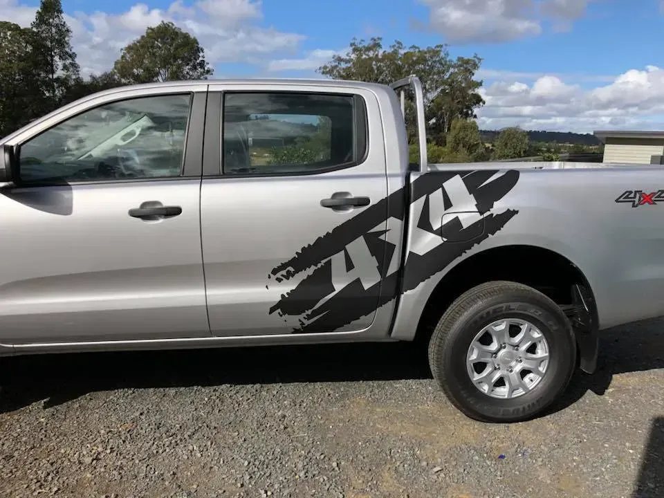 A silver truck with the word 4x4 on the side