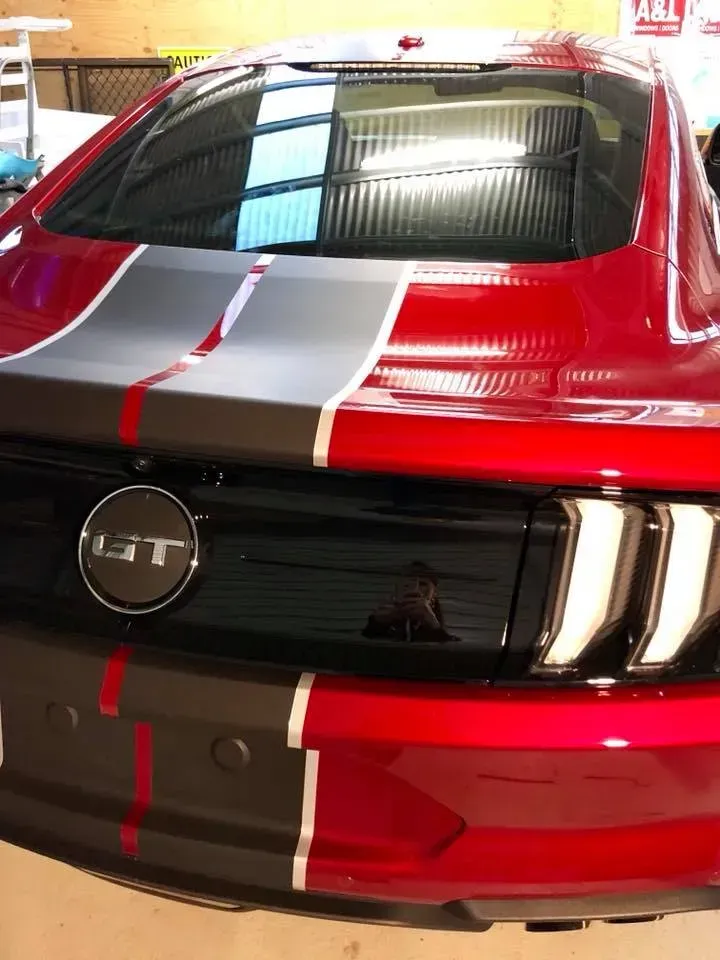 A red mustang with a gt logo on the front