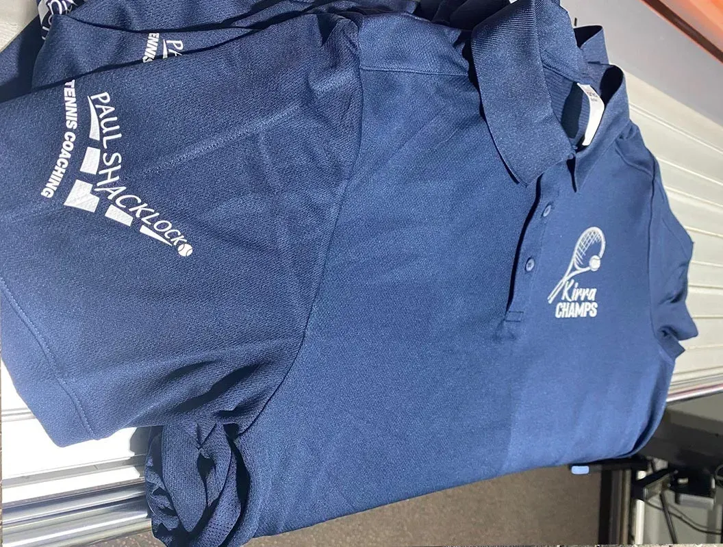 A stack of blue shirts with paul smith written on them