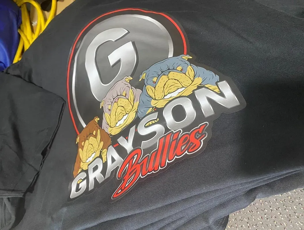 A grayson bullies sweatshirt is laying on a table