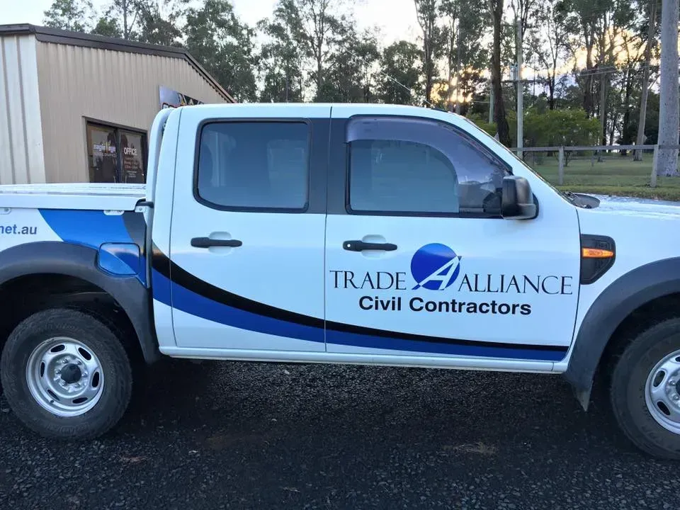 A white truck with the words trade alliance civil contractors on the side