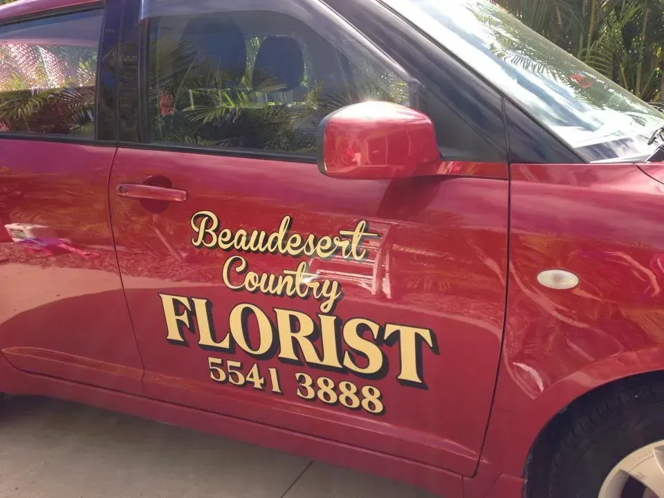 A red car with the word florist on the side