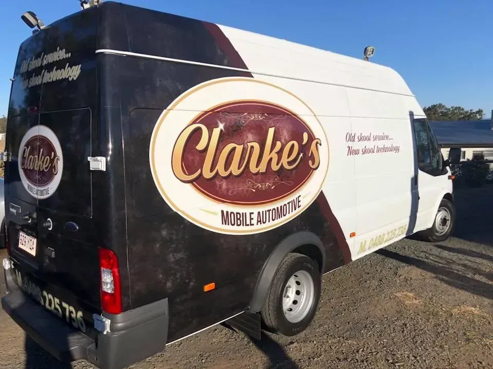 A clarke 's van is parked in a parking lot