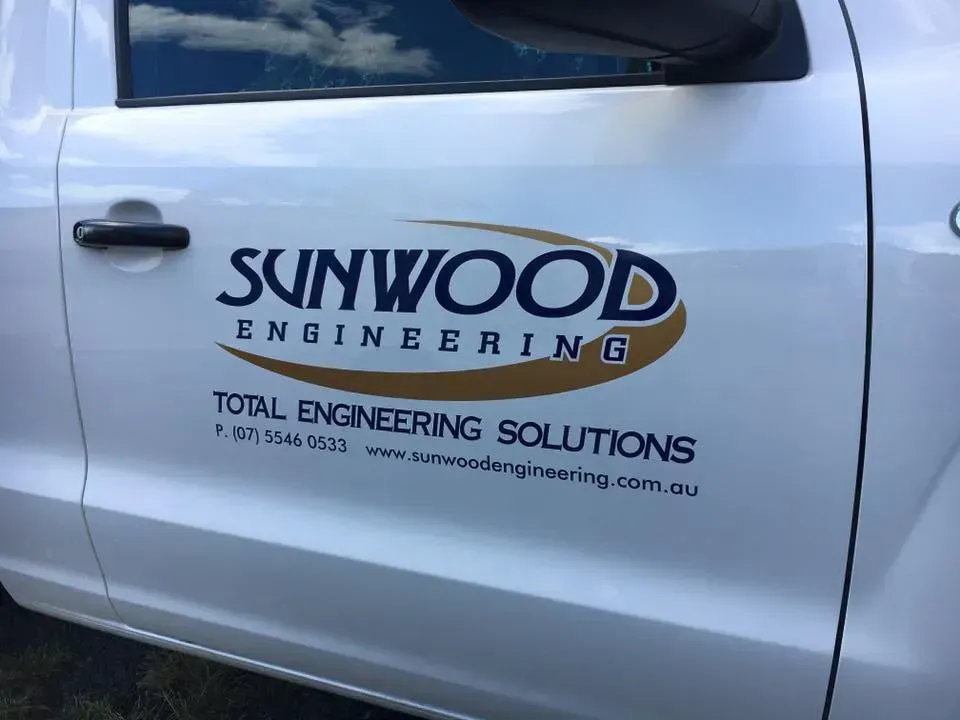 A white truck with a sunwood engineering logo on the door